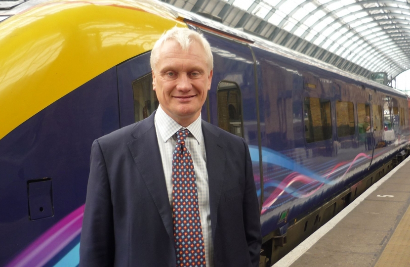 Graham standing in front of a train in Beverley Train Station.