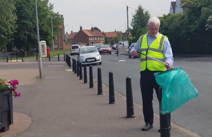 Graham litter picking in the Samman road play area.