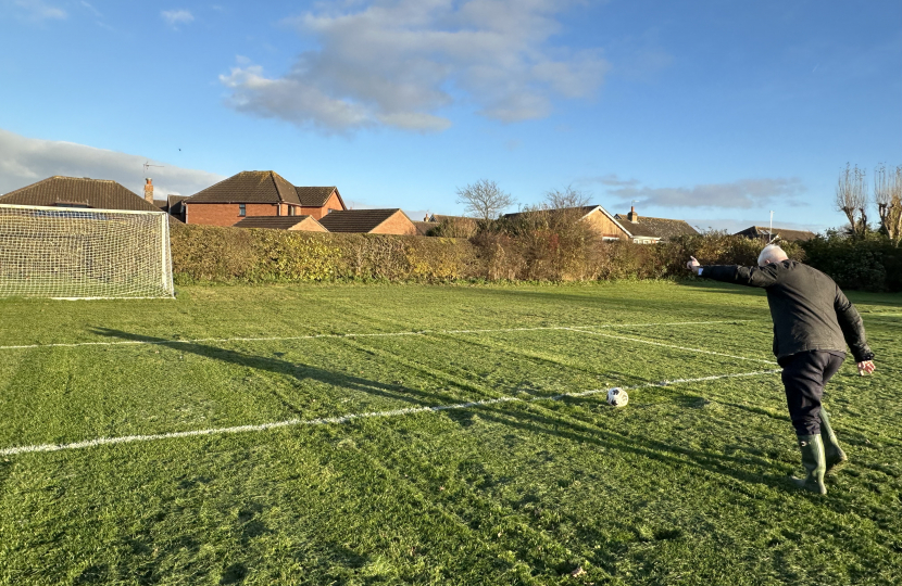 Graham kicking a football