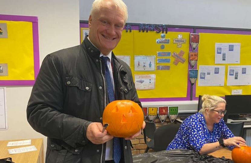 Photo of Graham Stuart carving a pumpkin at Withernsea High School