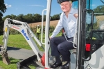 Graham sitting in an excavator