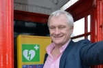 Graham inside a red telephone box housing a CPAD