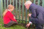 Graham planting a tree with their School Eco-Minister Angel