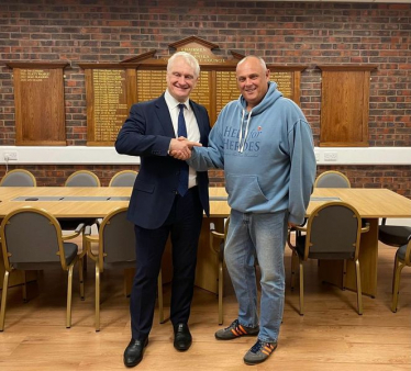 Darren England and Graham Stuart MP shaking hands