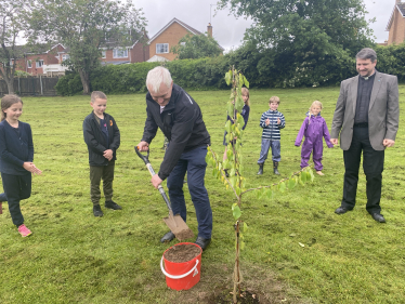 Graham planting tree at Cherry Burton Primary School